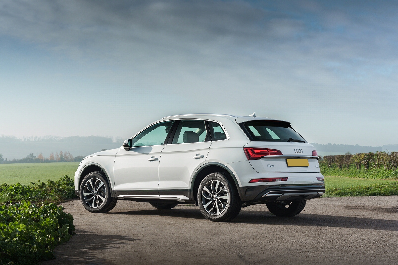 White Audi Q5 parked by a field