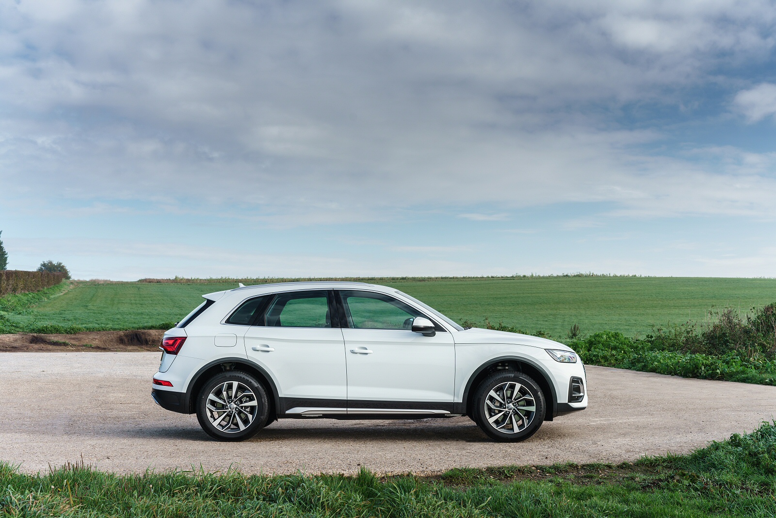 White Audi Q5 parked by a field