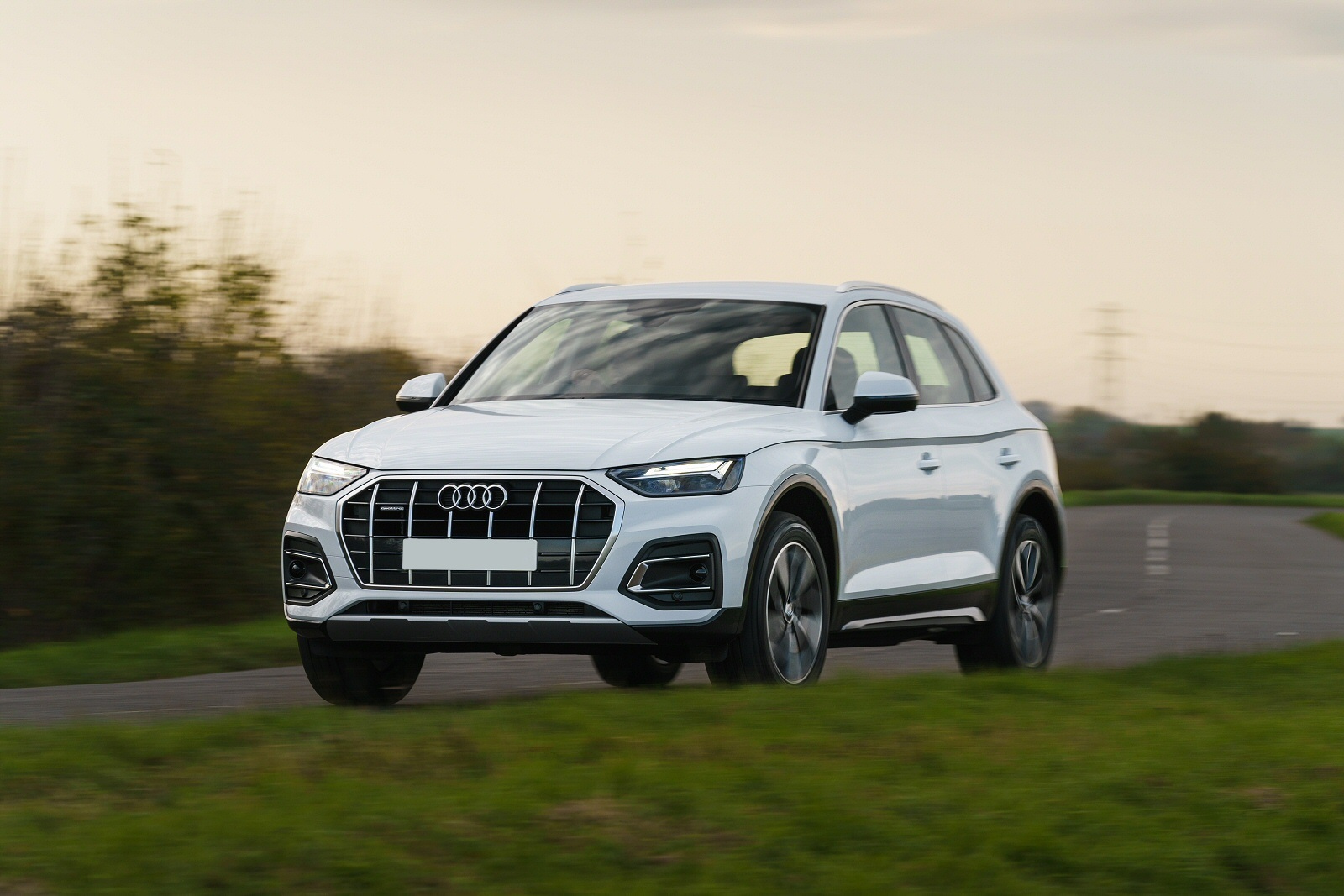 White Audi Q5 driving on a country road